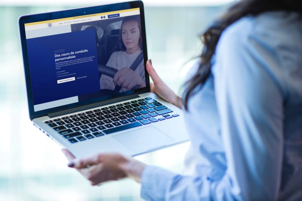 Driving school website shown on a laptop
